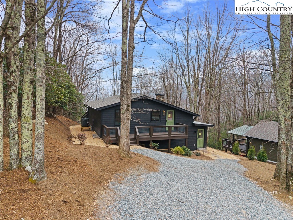 212 Chinkapin Ridge Road Seven Devils, NC 28604 - Photo 19 of 21 a view of a house with a yard and garage