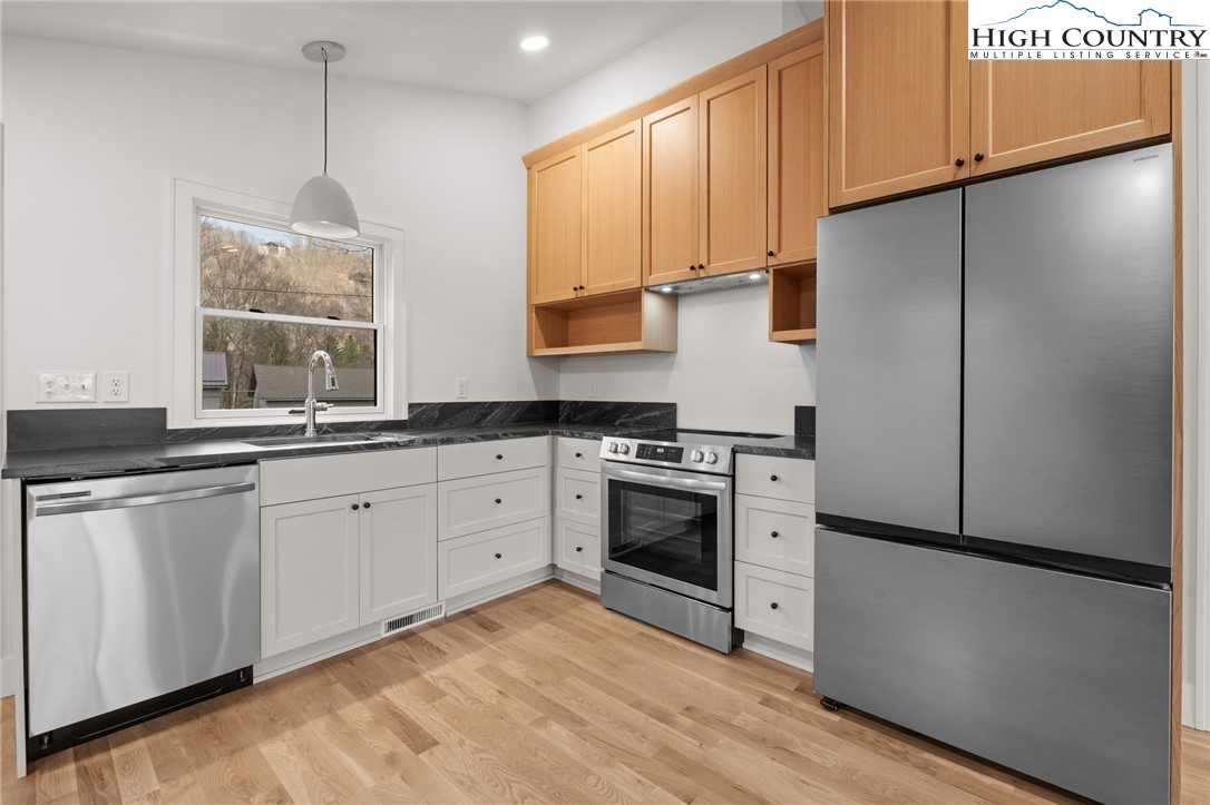 212 Chinkapin Ridge Road Seven Devils, NC 28604 - Photo 2 of 21 a kitchen with stainless steel appliances a refrigerator sink and cabinets