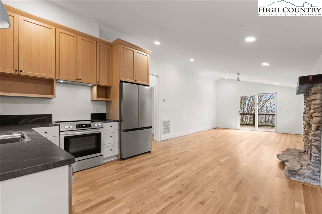 212 Chinkapin Ridge Road Seven Devils, NC 28604 - Photo 3 of 21 a kitchen with stainless steel appliances granite countertop a refrigerator sink and stove