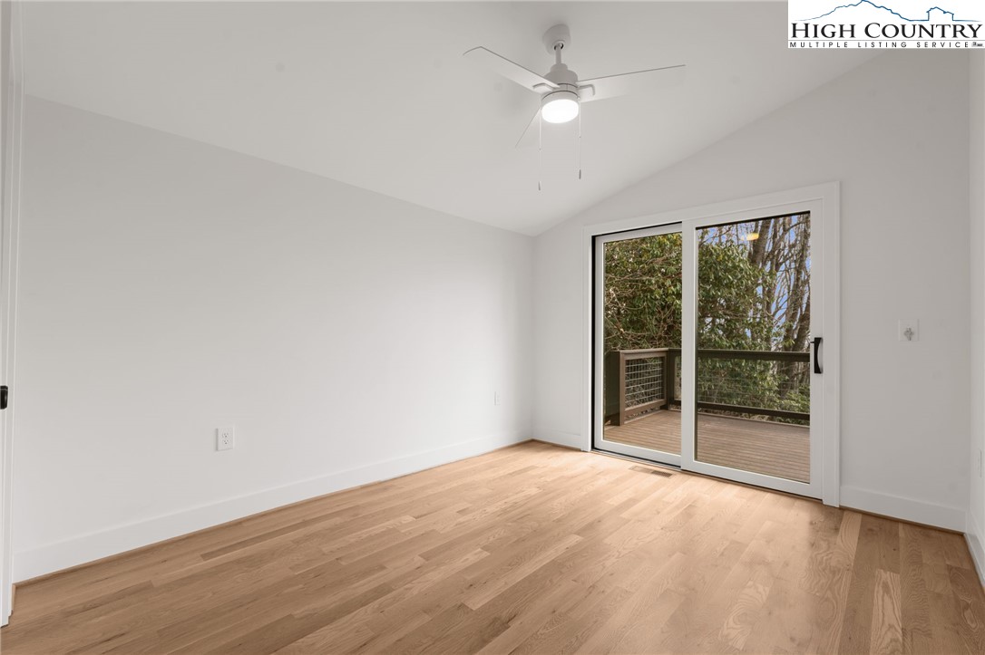 212 Chinkapin Ridge Road Seven Devils, NC 28604 - Photo 5 of 21 an empty room with wooden floor and fan