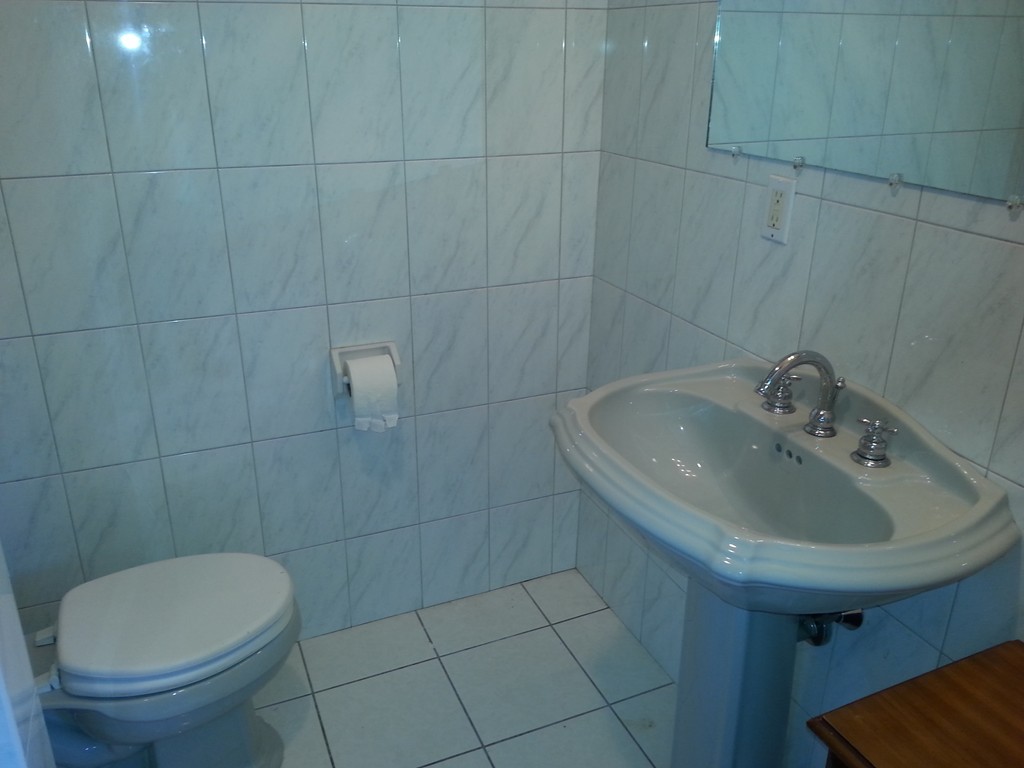 26 Lorenzo Street Springfield, MA 01109 - Photo 11 of 12 a bathroom with a sink toilet and a mirror