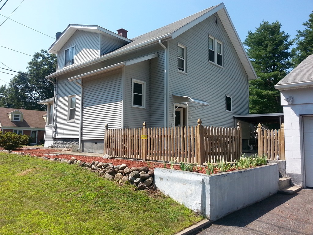 26 Lorenzo Street Springfield, MA 01109 - Photo 2 of 12 a front view of a house with a garden