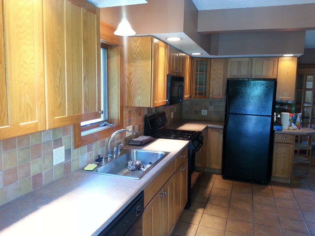26 Lorenzo Street Springfield, MA 01109 - Photo 8 of 12 a kitchen with a sink refrigerator and cabinets