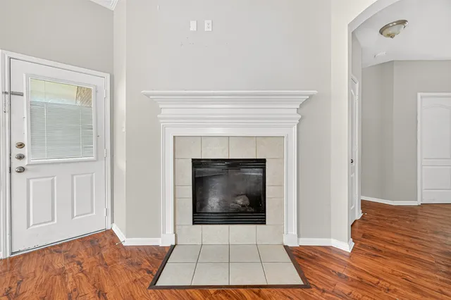 a living room with a fireplace and a rug