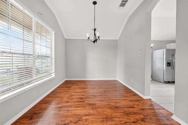 a view of a room with a ceiling fan and window