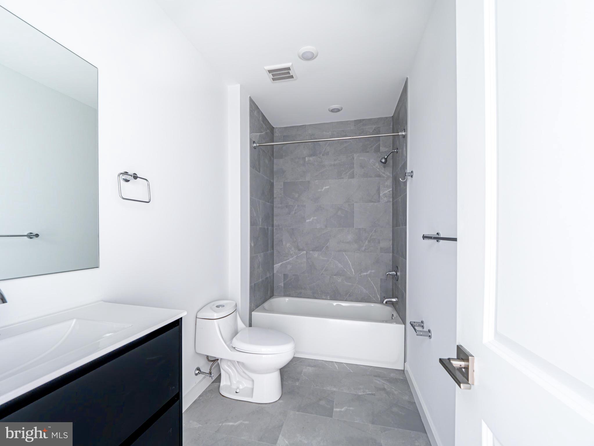 2403-2407 West Thompson Street, Unit 4 Philadelphia, PA 19121 - Photo 6 of 13 a bathroom with a bathtub and a toilet