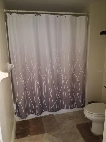 a bathroom with a shower curtain and sink