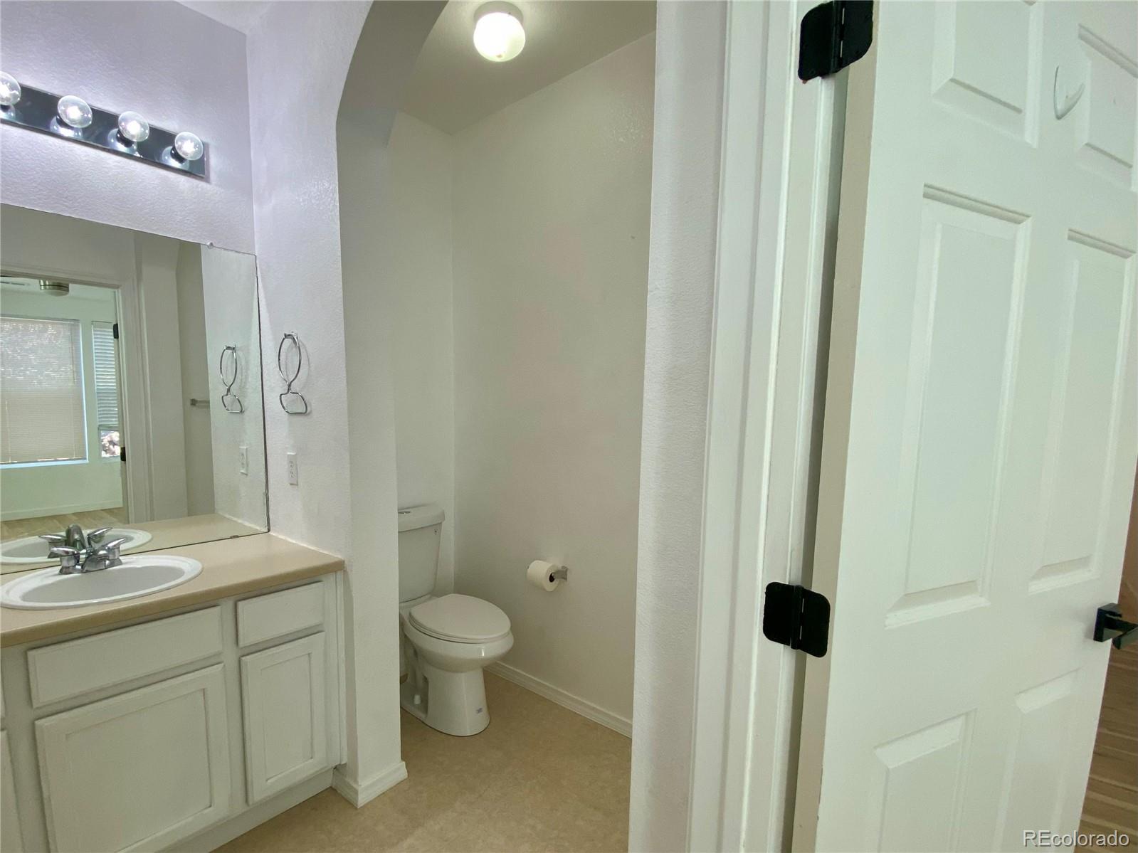 6722 South Winnipeg Circle, Unit 103 Aurora, CO 80016 - Photo 14 of 19 a bathroom with a sink and a mirror