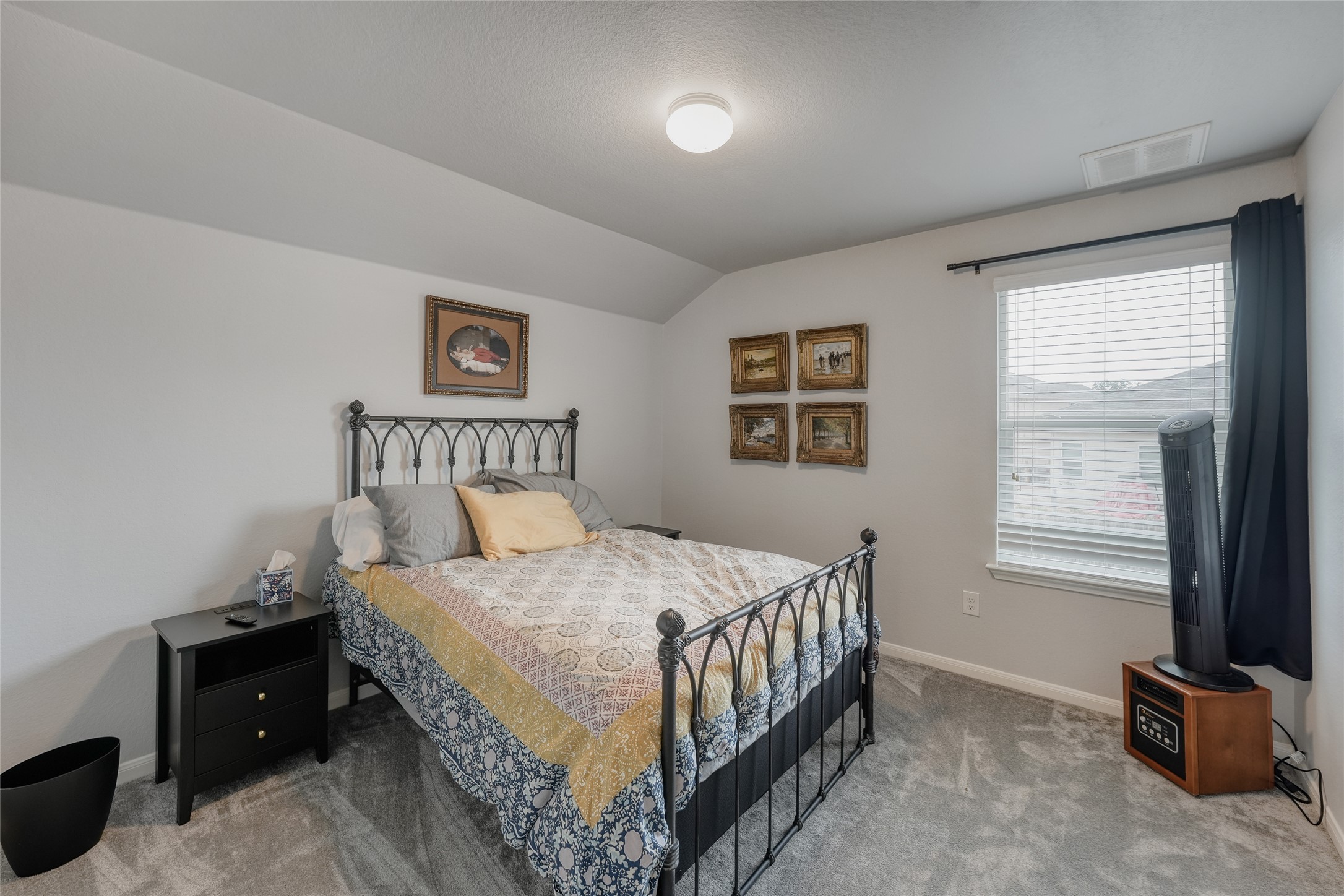 15105 Shell Bark Cove Austin, TX 78724 - Photo 18 of 30 Cozy bedroom with textured carpet flooring and a generously sized window for natural light.
