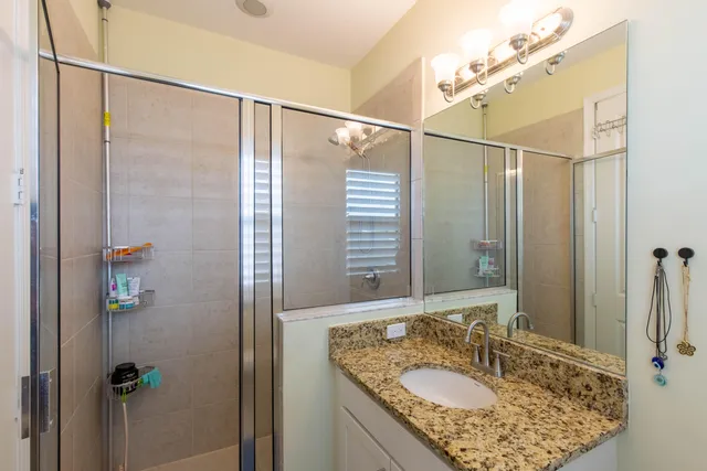 a bedroom with a bed table chair and a window