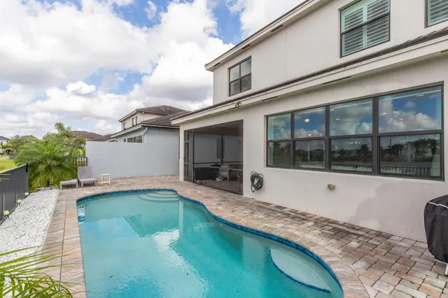 a view of swimming pool with outdoor seating and plants