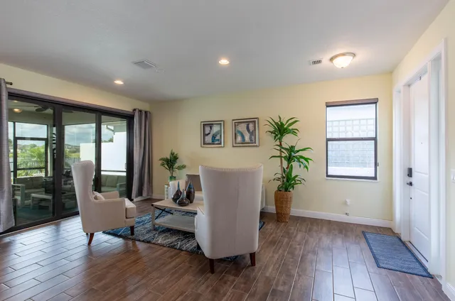 a living room with furniture and wooden floor