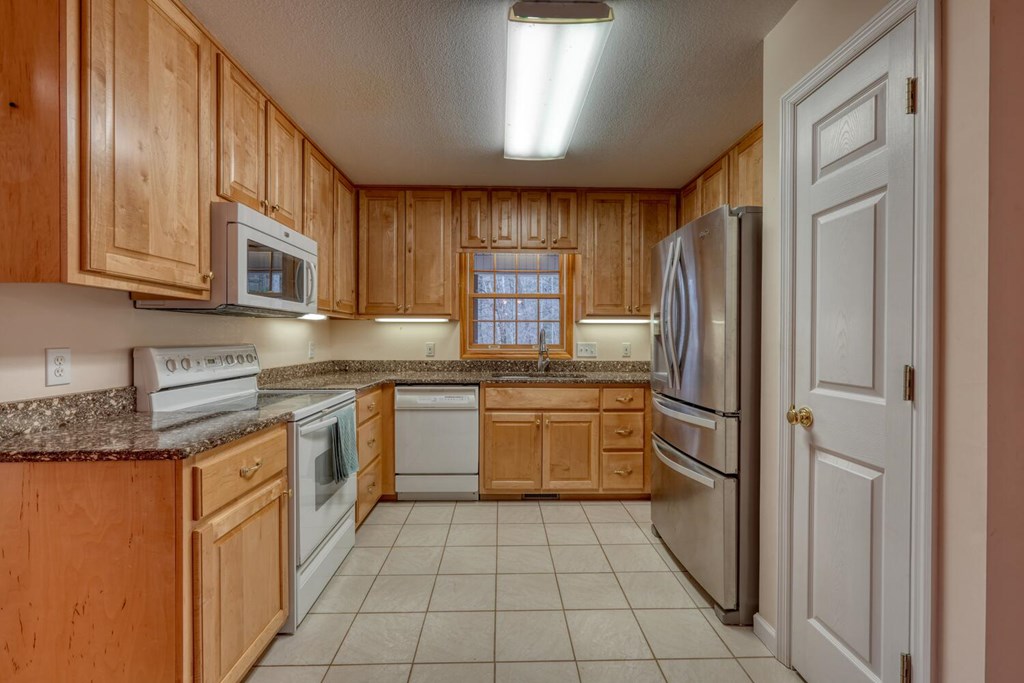 2478 High River Road Hiawassee, GA 30546 - Photo 14 of 67 a kitchen with stainless steel appliances granite countertop a refrigerator and a stove top oven