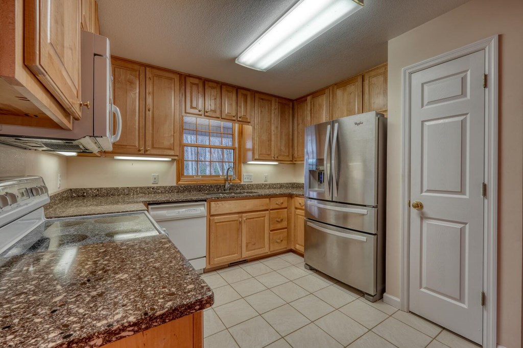 2478 High River Road Hiawassee, GA 30546 - Photo 15 of 67 a kitchen with stainless steel appliances granite countertop a refrigerator and a sink
