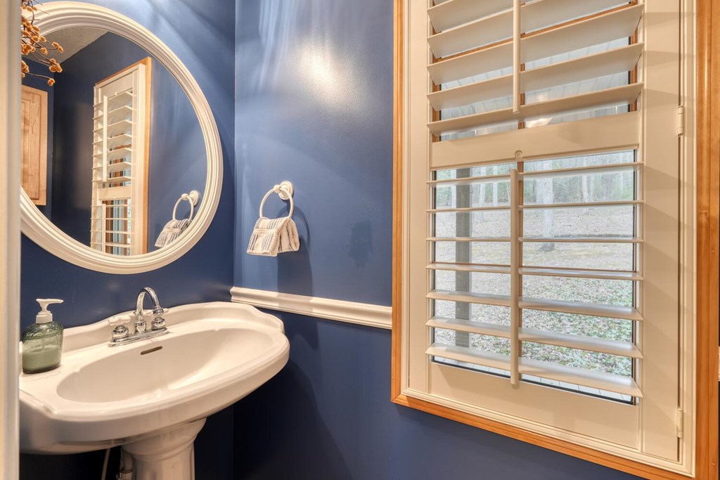 2478 High River Road Hiawassee, GA 30546 - Photo 24 of 67 a bathroom with a sink and a mirror