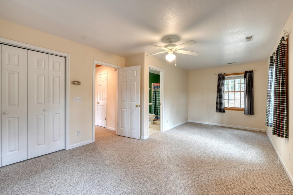 2478 High River Road Hiawassee, GA 30546 - Photo 28 of 67 an empty room with windows and fan chandelier