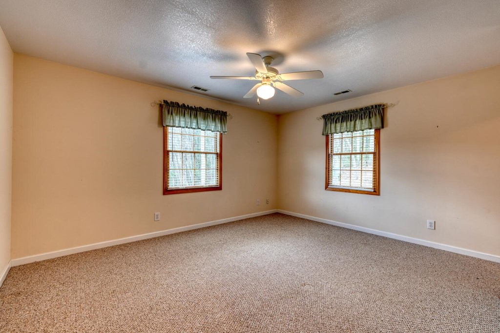2478 High River Road Hiawassee, GA 30546 - Photo 31 of 67 an empty room with windows and ceiling fan