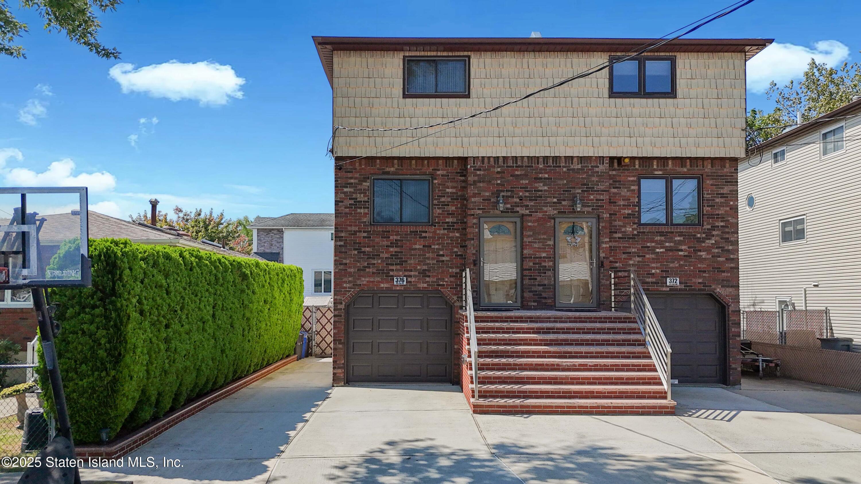 376 Adelaide Avenue Staten Island, NY 10306 - Photo 1 of 42 a front view of a house with a garden