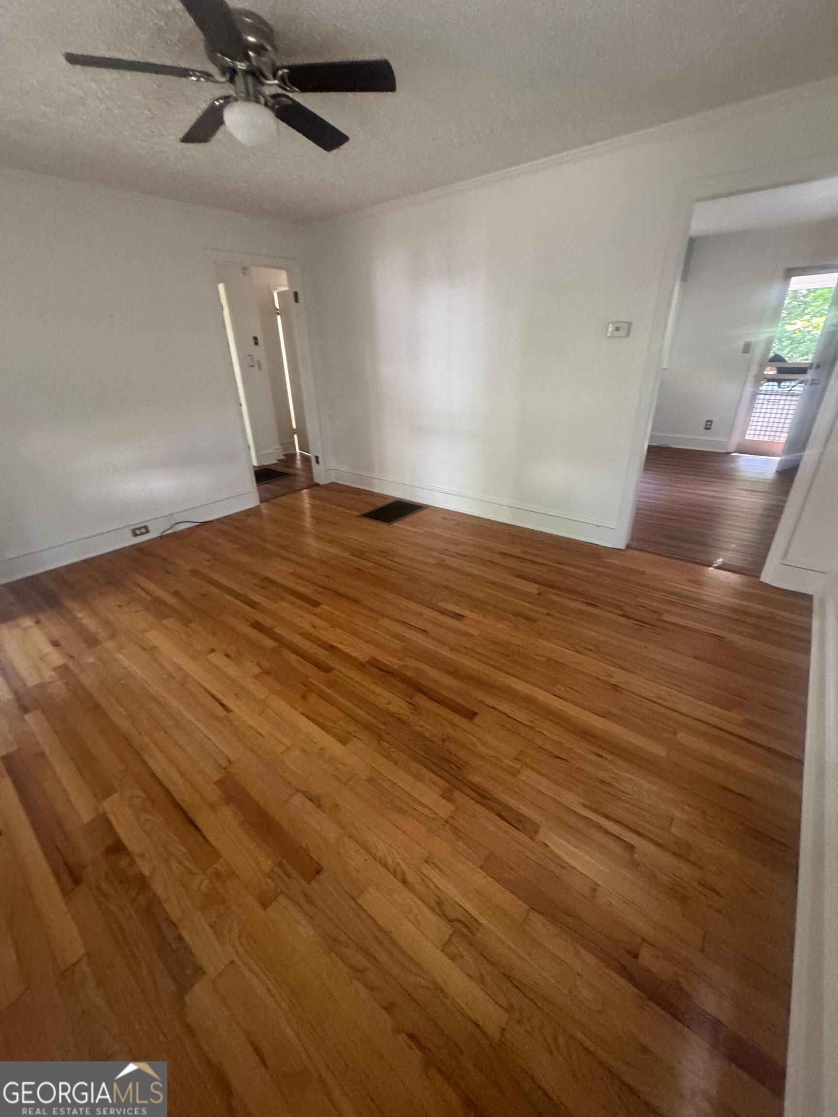 609 West Main Street Thomaston, GA 30286 - Photo 11 of 27 wooden floor in an empty room