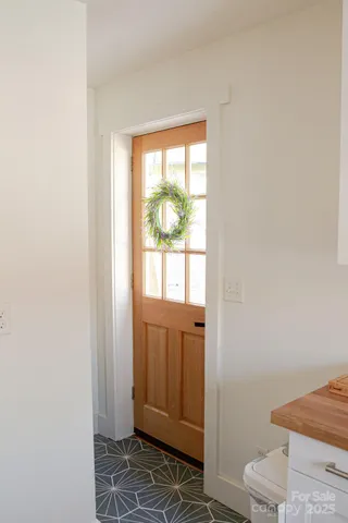 a kitchen with a sink window and cabinets