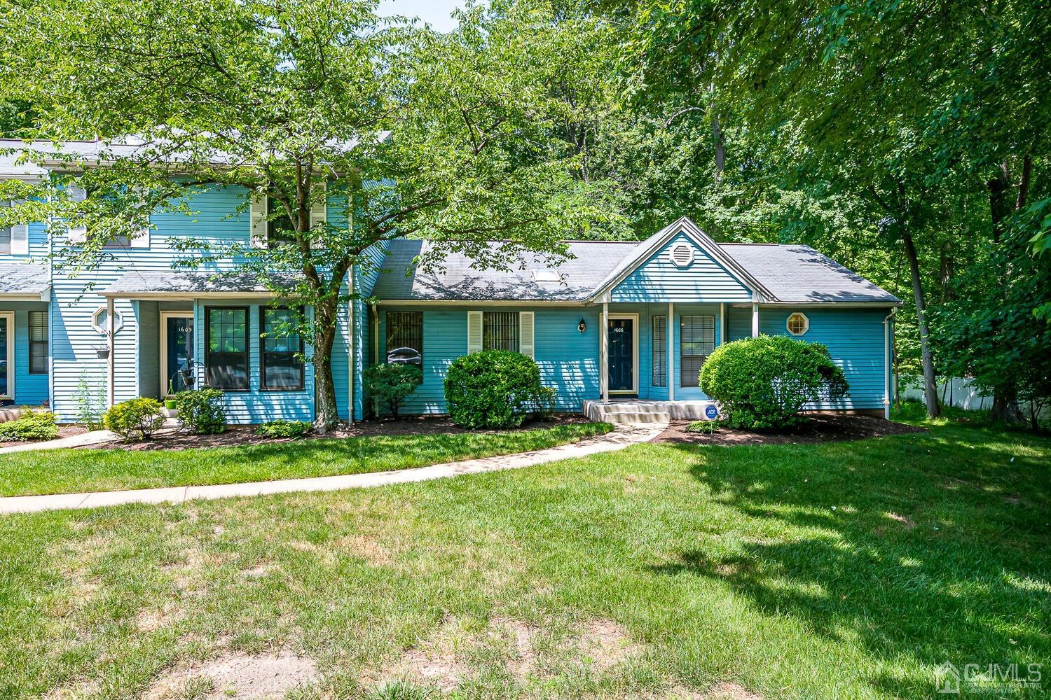 1606 Timber Oaks Road Edison, NJ 08820 - Photo 2 of 33 a front view of a house with a yard and porch