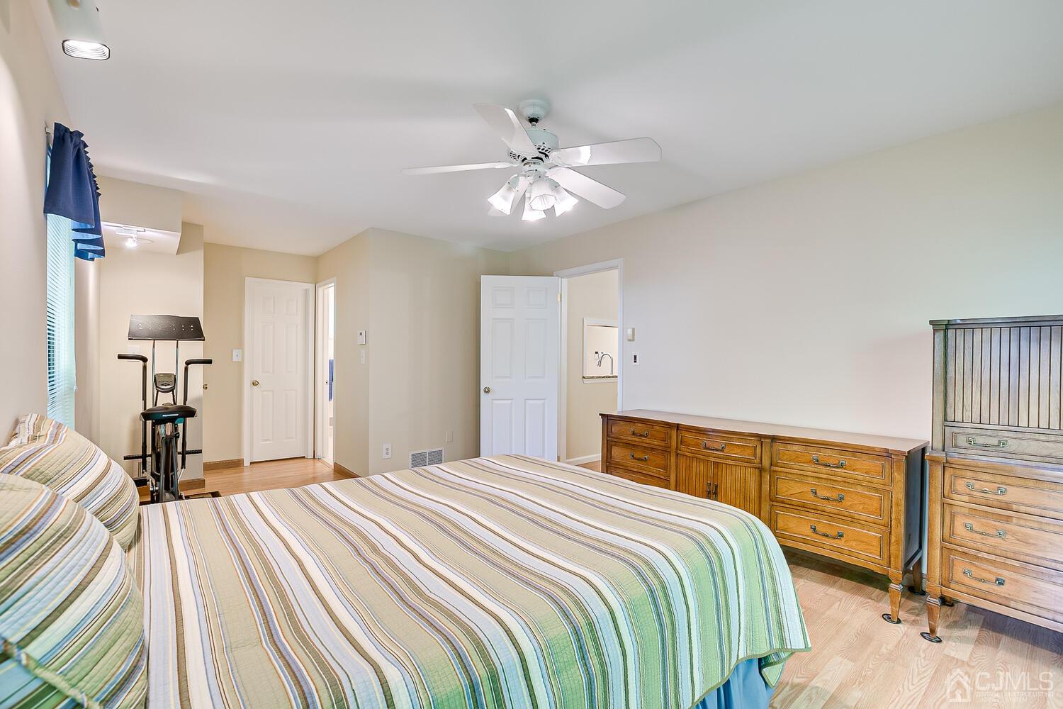 1606 Timber Oaks Road Edison, NJ 08820 - Photo 22 of 33 a bedroom with a bed and a chandelier