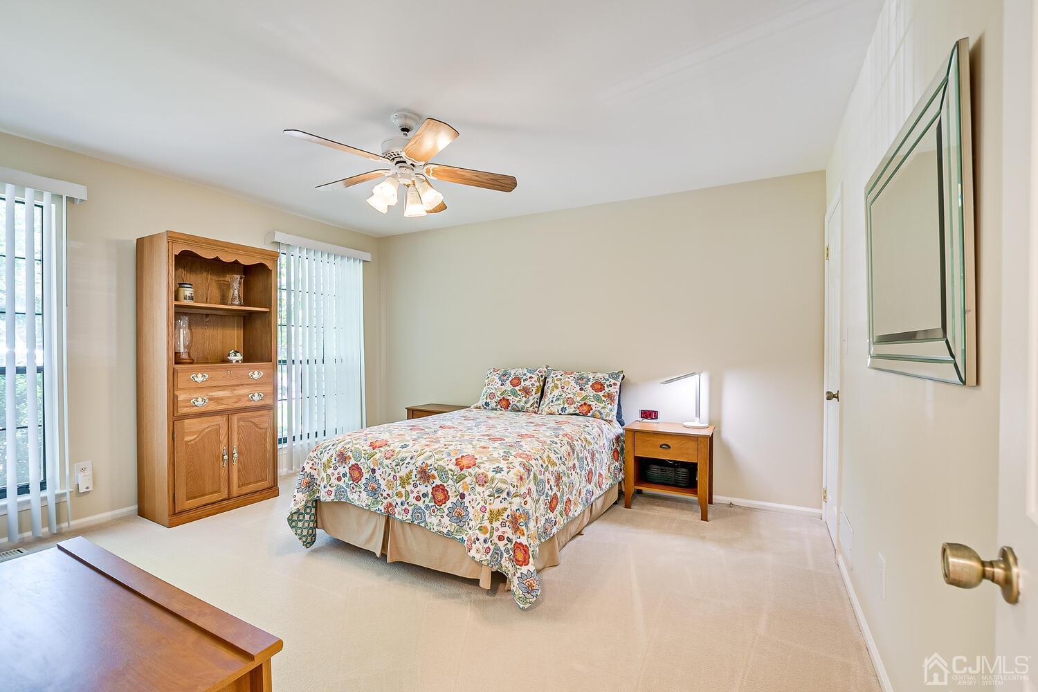 1606 Timber Oaks Road Edison, NJ 08820 - Photo 25 of 33 a bedroom with a bed and a chandelier