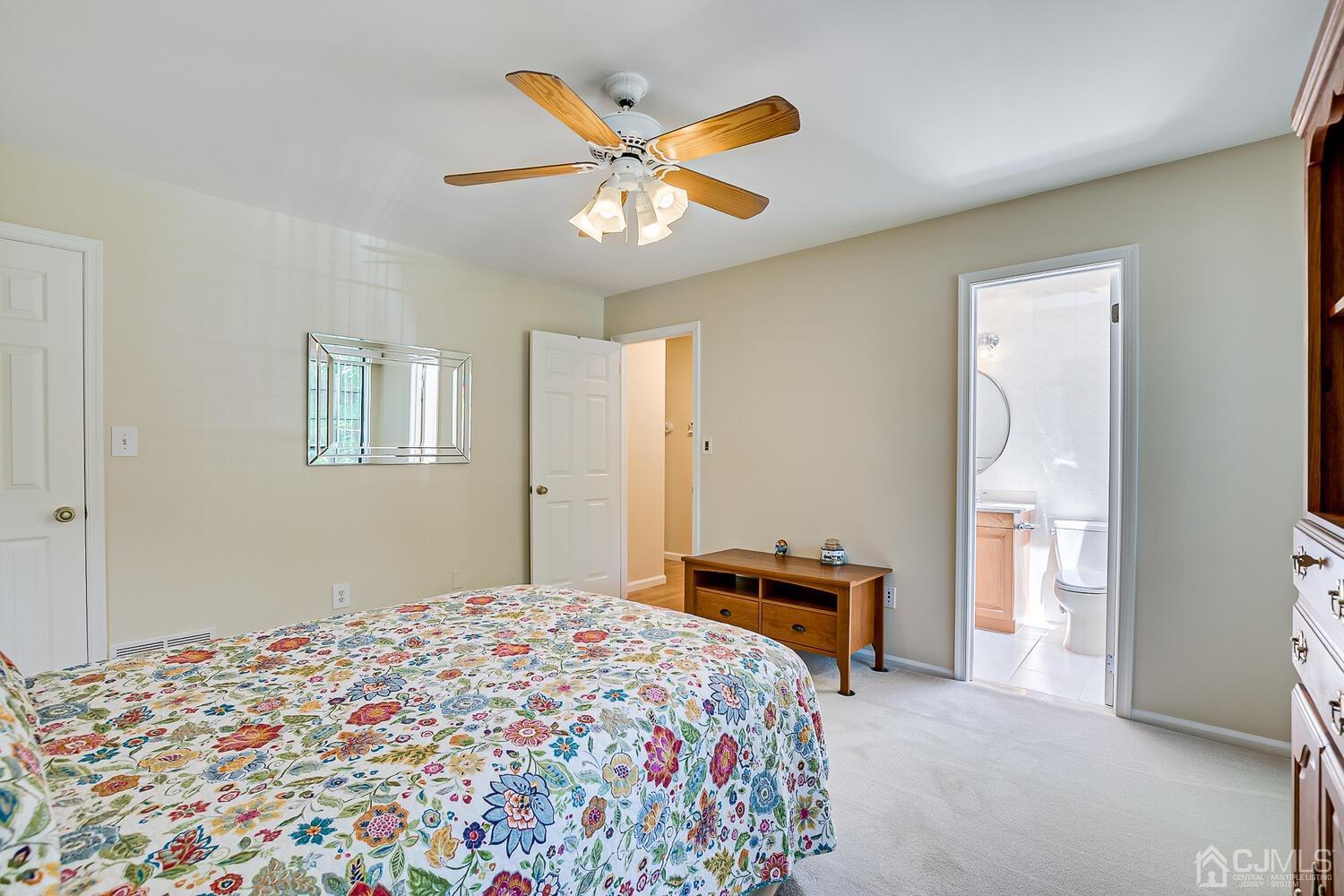 1606 Timber Oaks Road Edison, NJ 08820 - Photo 26 of 33 a bedroom that has a bed and a chandelier
