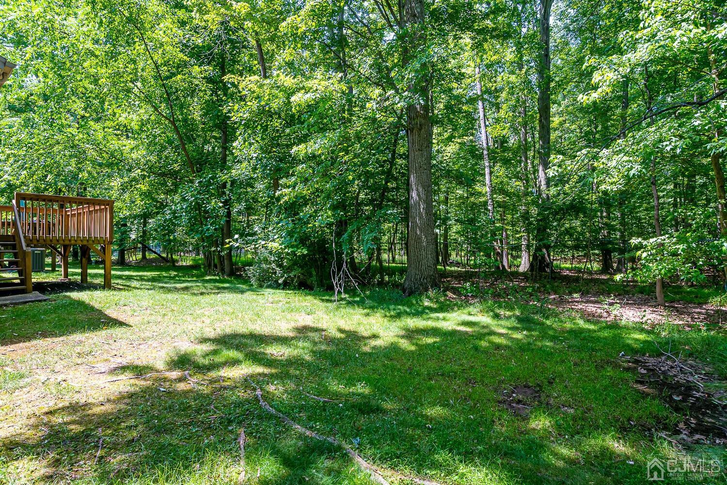 1606 Timber Oaks Road Edison, NJ 08820 - Photo 32 of 33 a backyard of a house with lots of green space and fountain