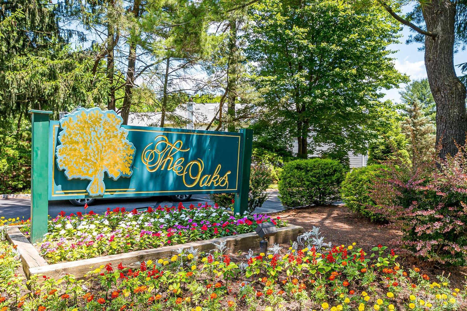 1606 Timber Oaks Road Edison, NJ 08820 - Photo 33 of 33 a sign that is in front of flowers
