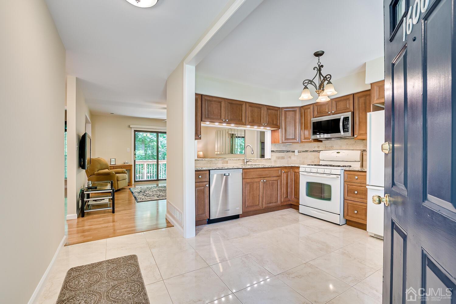 1606 Timber Oaks Road Edison, NJ 08820 - Photo 5 of 33 a kitchen with a sink stainless steel appliances and white cabinets