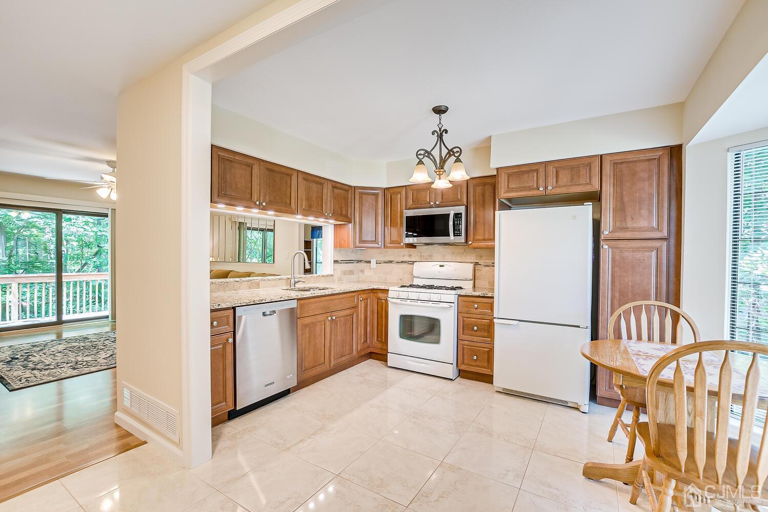 1606 Timber Oaks Road Edison, NJ 08820 - Photo 6 of 33 a kitchen with white cabinets and white appliances