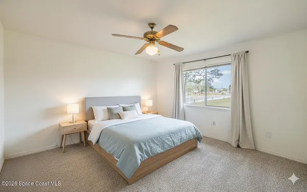 a bedroom with a bed and window