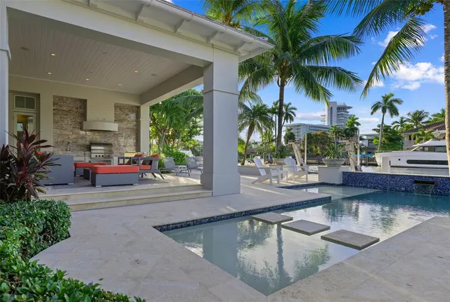 a view of a swimming pool with furniture