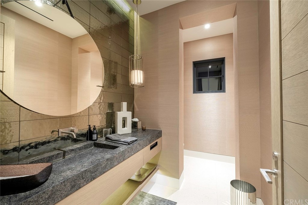 12 Swimmers Newport Coast, CA 92657 - Photo 14 of 38 a bathroom with a granite countertop sink and a mirror