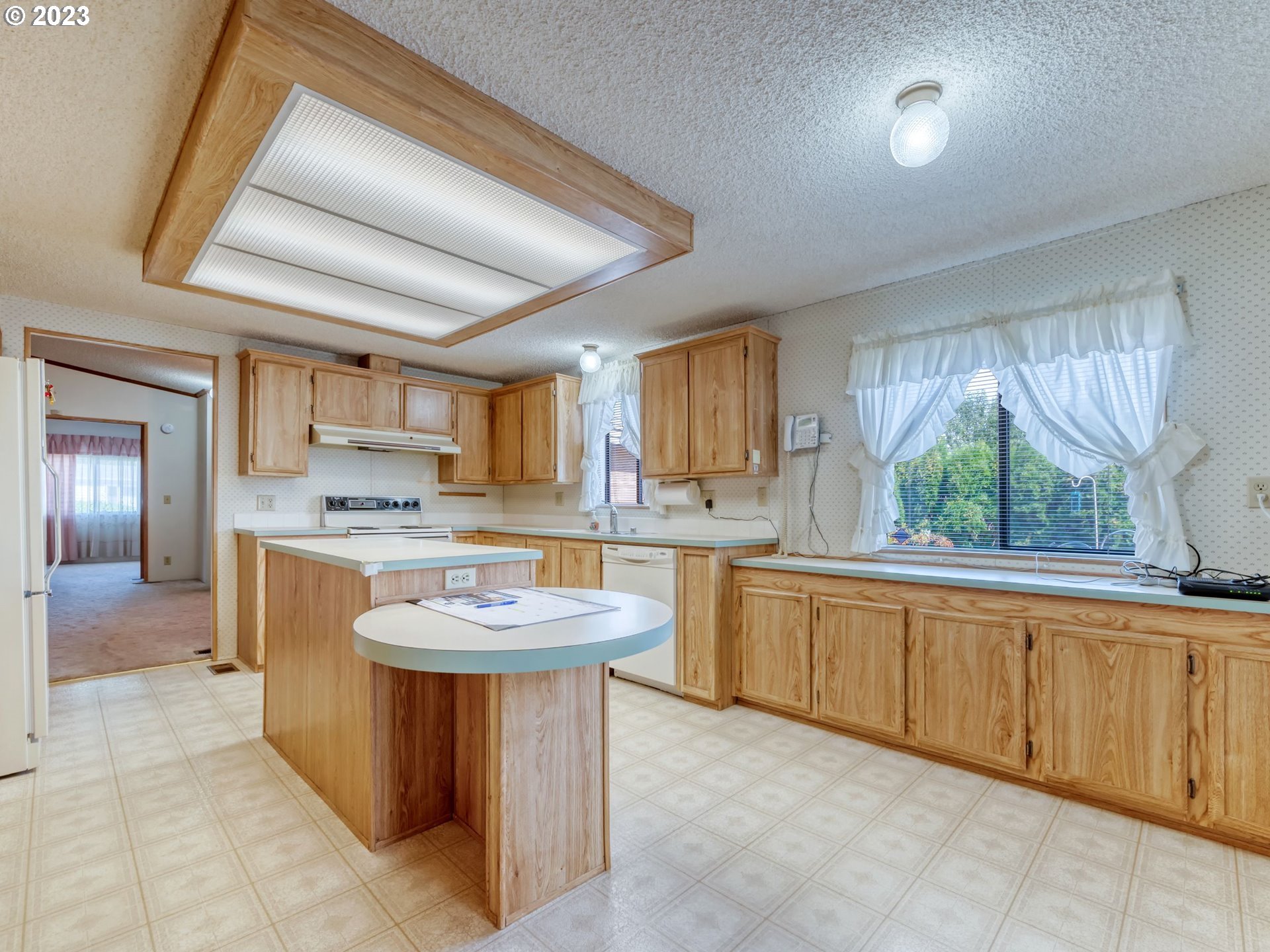 1199 North Terry Street Eugene, OR 97402 - Photo 11 of 32 a kitchen with a sink refrigerator and cabinets