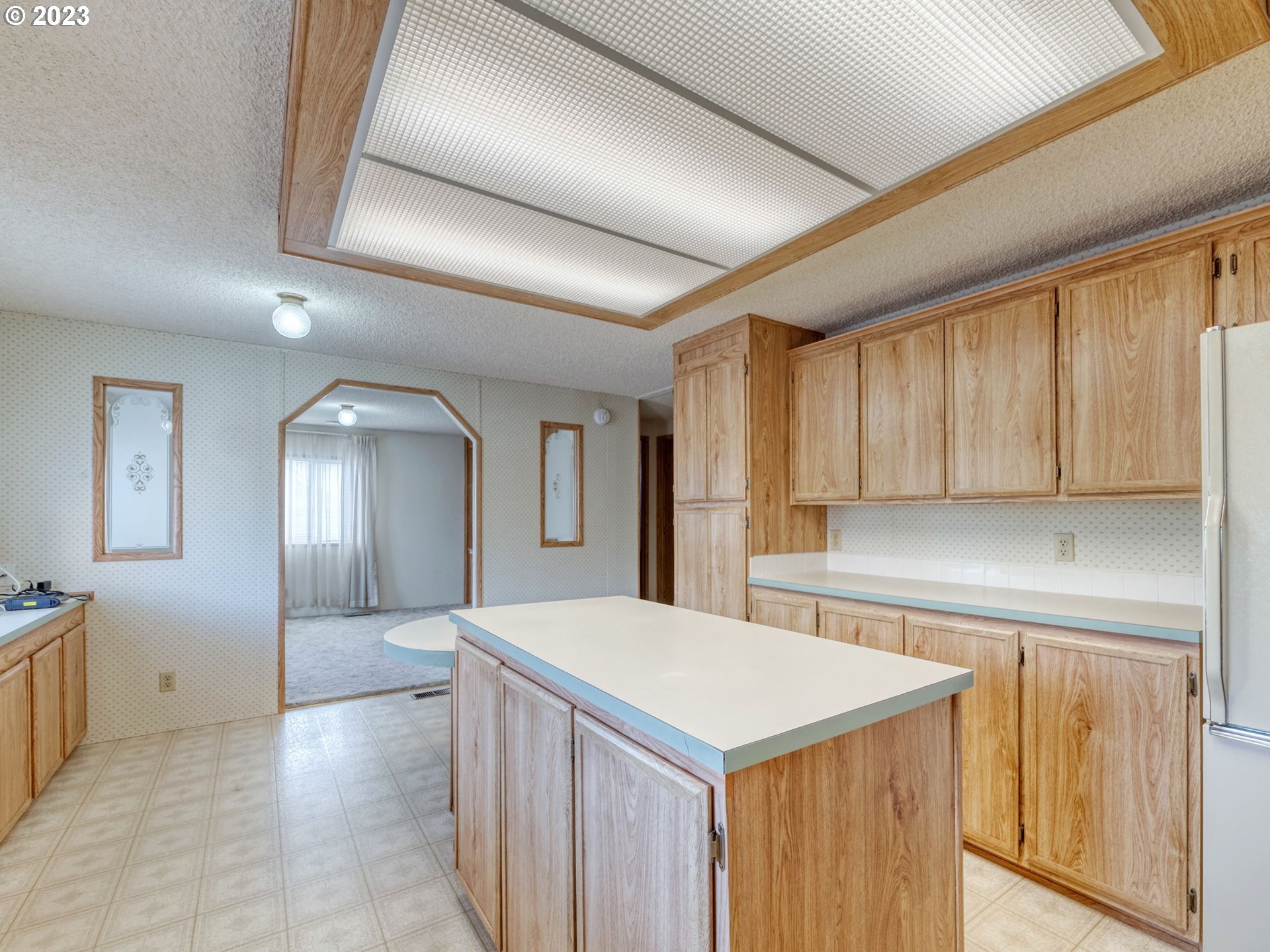 1199 North Terry Street Eugene, OR 97402 - Photo 13 of 32 a large kitchen with a sink a refrigerator and a stove top oven