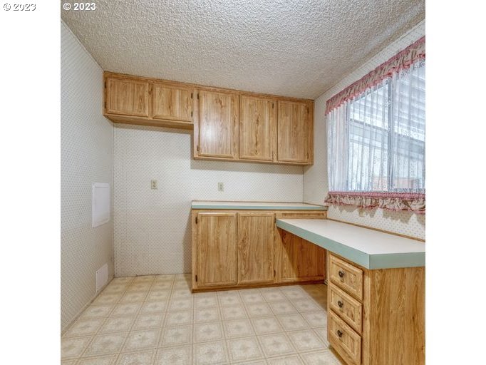 1199 North Terry Street Eugene, OR 97402 - Photo 17 of 32 a kitchen with a sink and cabinets