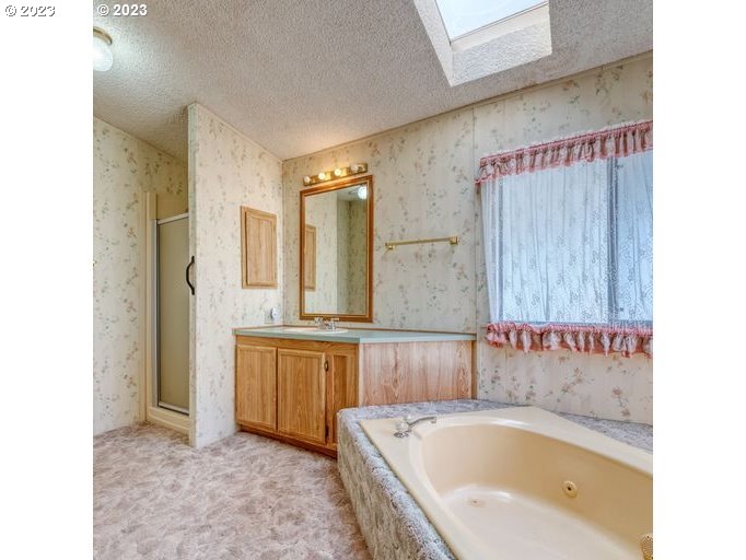 1199 North Terry Street Eugene, OR 97402 - Photo 21 of 32 a bathroom with a bathtub and a sink