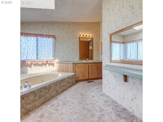 1199 North Terry Street Eugene, OR 97402 - Photo 22 of 32 a bathroom with a bathtub and a sink