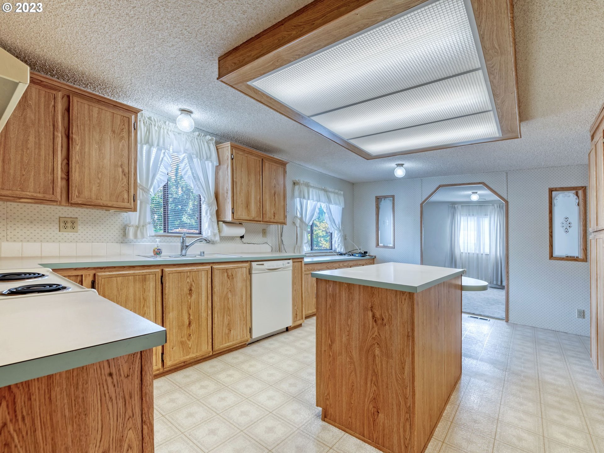 1199 North Terry Street Eugene, OR 97402 - Photo 10 of 32 a kitchen with a stove a sink a refrigerator and cabinets