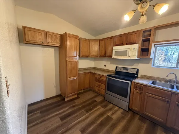 a kitchen with stainless steel appliances a refrigerator stove and sink