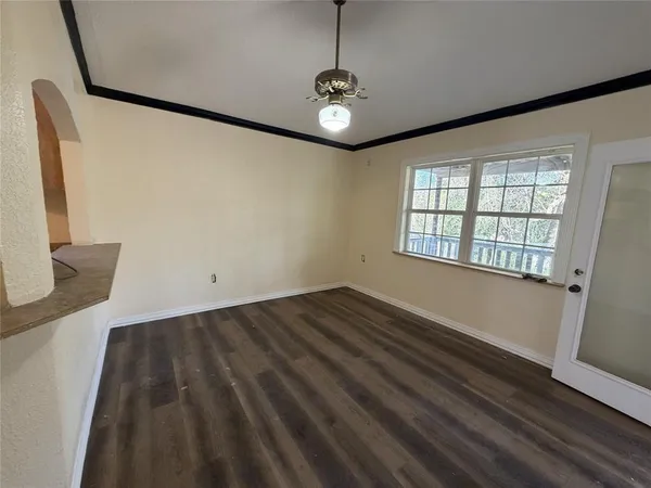 a view of a livingroom with wooden floor and a window