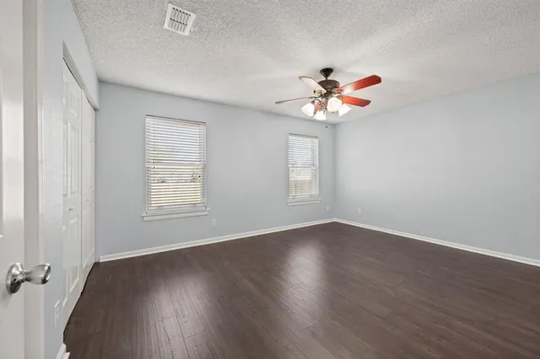 a view of an empty room with a ceiling fan