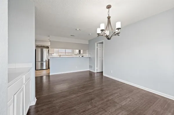 a view of a kitchen with wooden floor and a ceiling fan