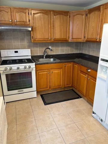 a kitchen with stainless steel appliances a stove a sink and a microwave