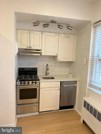 a kitchen with stainless steel appliances granite countertop a stove and a sink