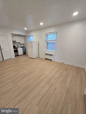 a view of a kitchen with a sink and a refrigerator