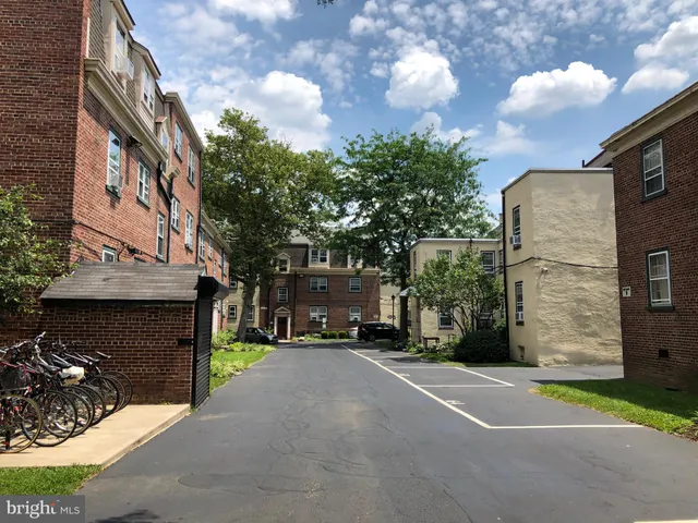 a view of a street with cars parked