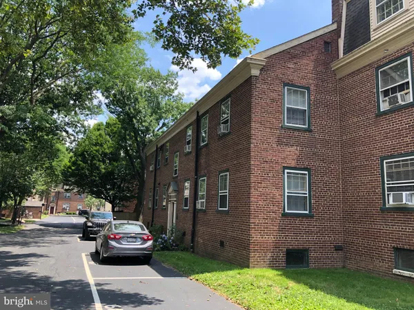 a car parked in front of a brick building
